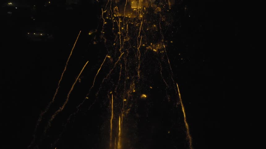 Fireworks shooting high into a night sky