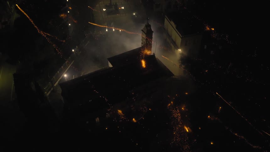 Fireworks shooting over a town at night