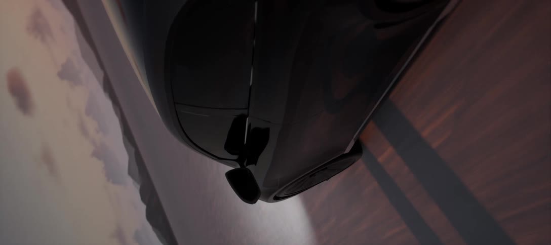 A luxury car shines its headlights while driving on a road with a cloudy sunrise sky