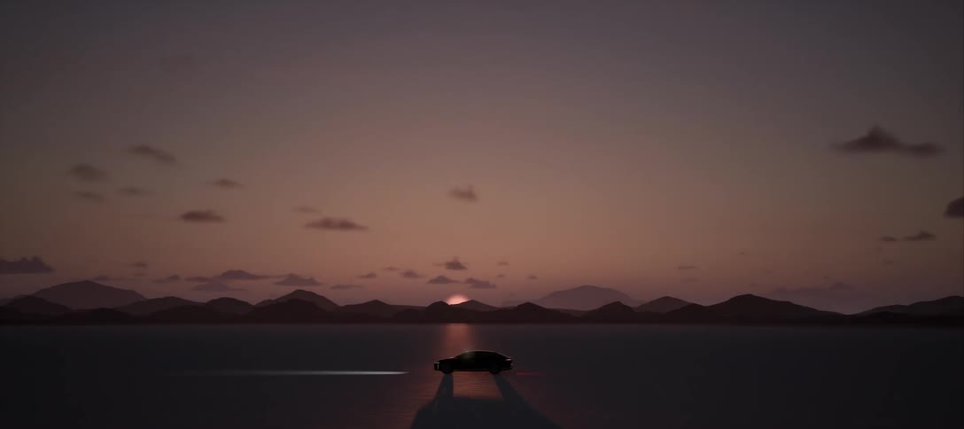 Luxury car at high speed through natural terrain with the silhouette of mountains on the horizon while sun rises