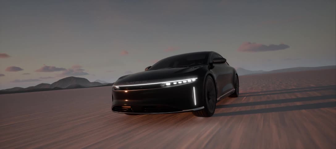 Modern luxury sports car traveling in a desert with silhouettes of mountains in the background