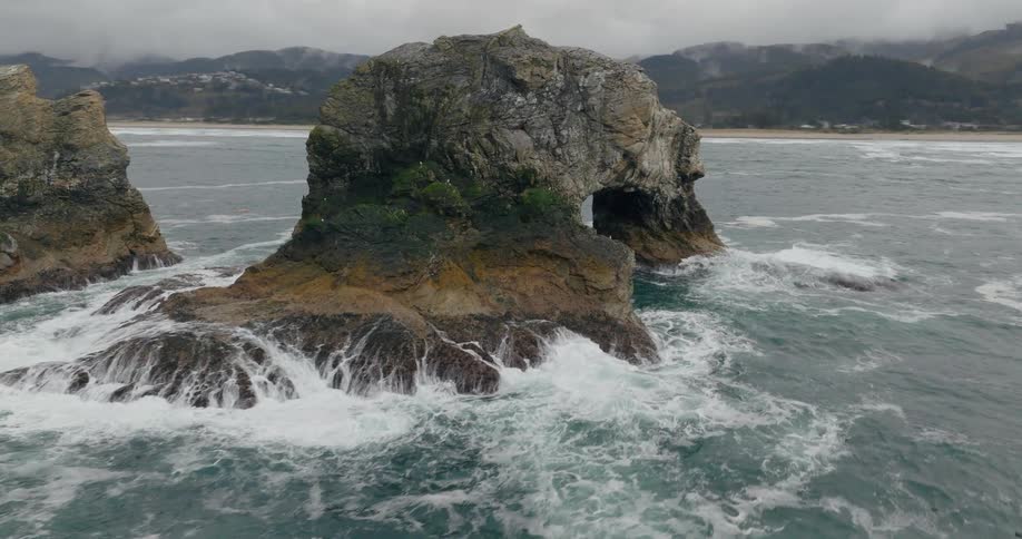 Aerial view of the rockaway beach rock formations with waves crashing against them