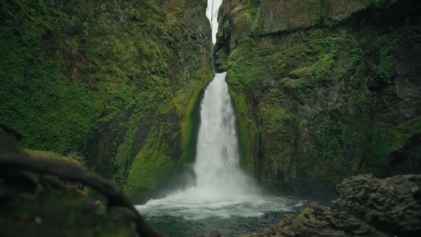 Waterfall in a natural environment with rocks around with mosses