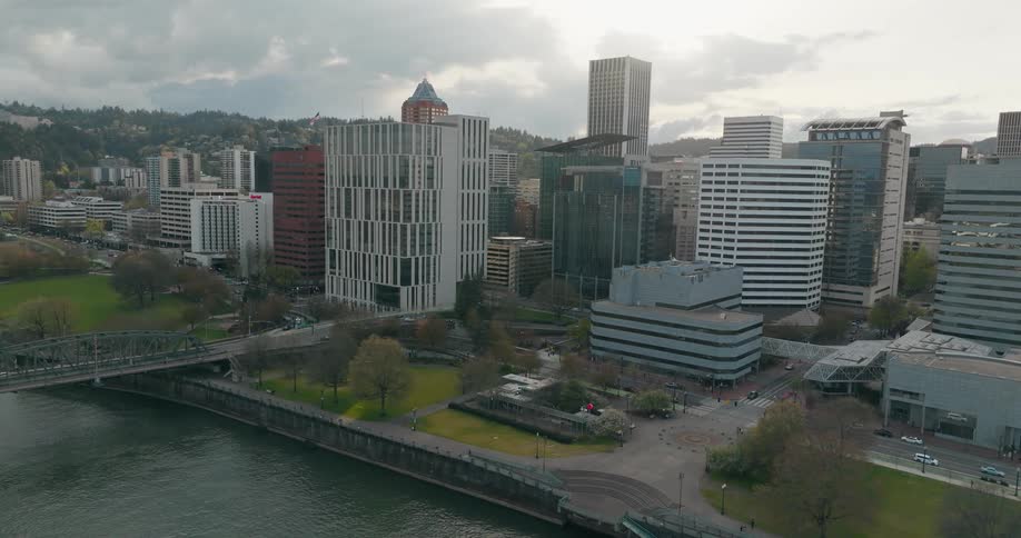 Aerial view of a cityscape with modern buildings a bridge and a river
