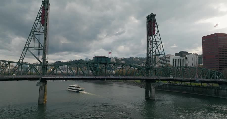 Aerial view of a ferry crossing under the hawthorne bridge in portland