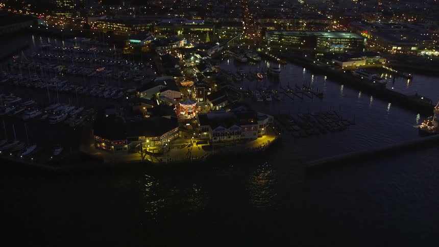 Aerial view of the san francisco skyline at night with the golden gate bridge in the foreground