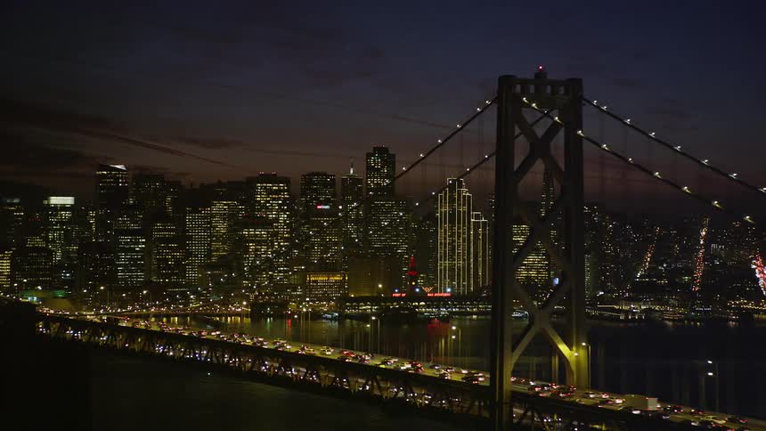Aerial view of the san francisco oakland bay bridge at night with the city skyline in the background