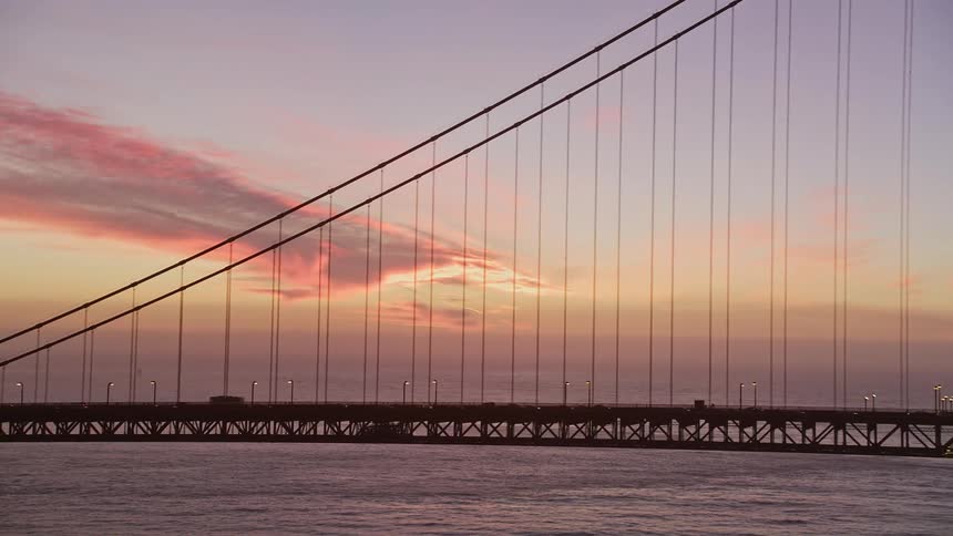 Extensive metal bridge over a vast ocean on a red sky day