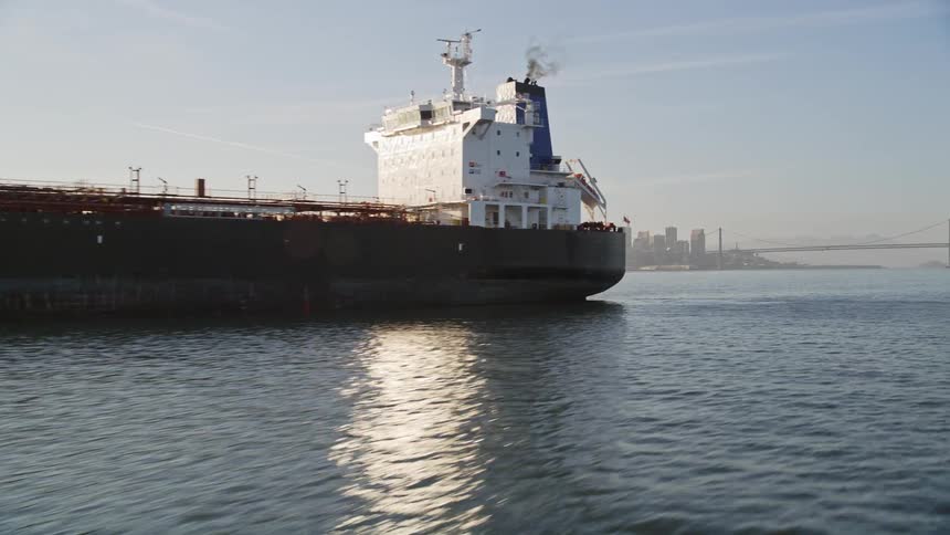 Aerial view of a large ship in front of the skyline of san francisco