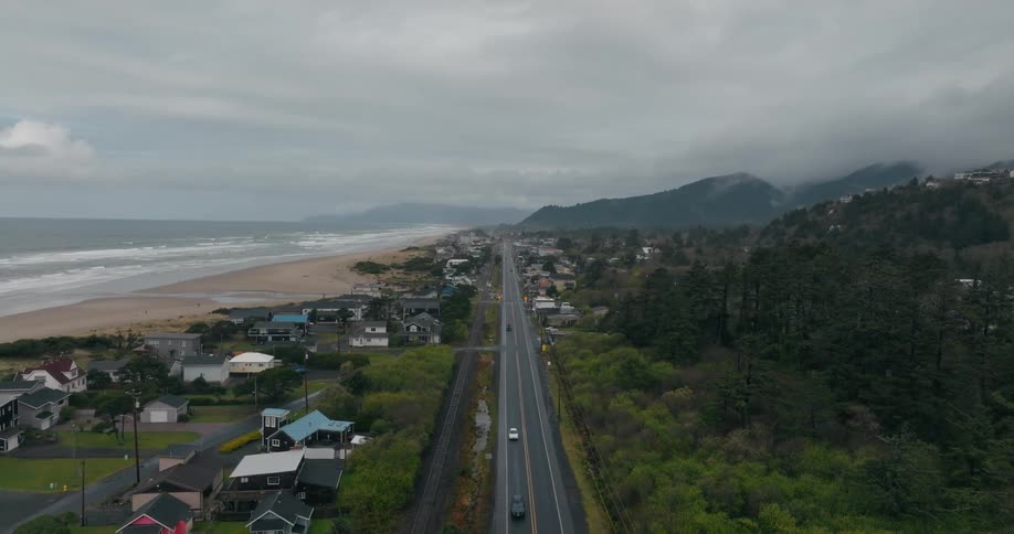 Cars drive on the road by the shore