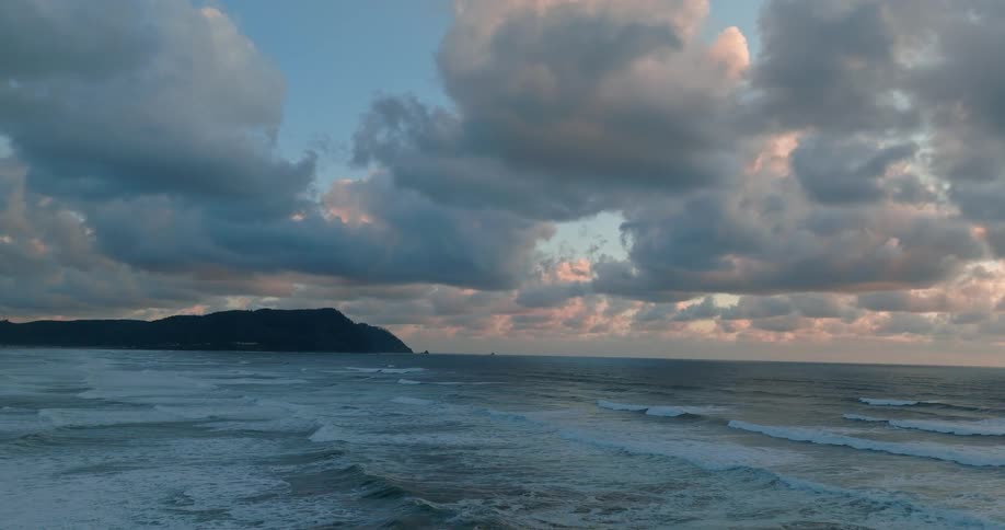 Stunning landscape of a beach with waves on a cloudy morning