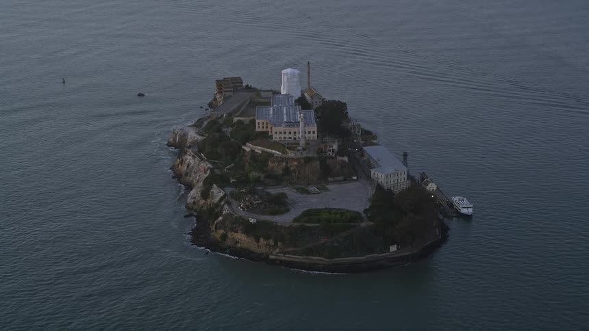Aerial panorama and an island with a viewpoint and an isolated building in the middle of the sea