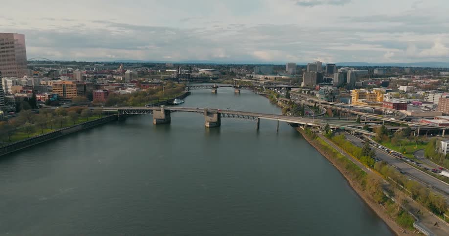 Maritime canal in the middle of a city with bridges and skyscrapers in the background