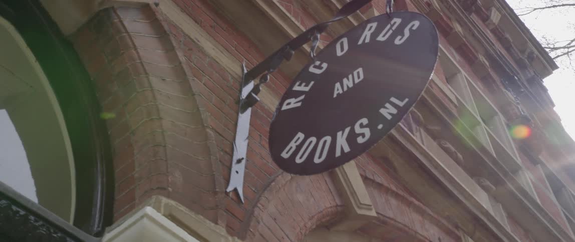 Hanging round signage of a retail shop selling records and books