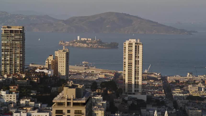 An aerial view of san francisco a hilly city with colorful buildings showing alcatraz island in the distance