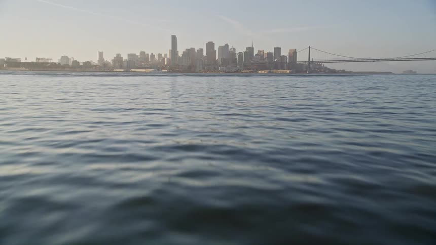Ocean with calm waters and in the background a metropolitan city with skyscrapers