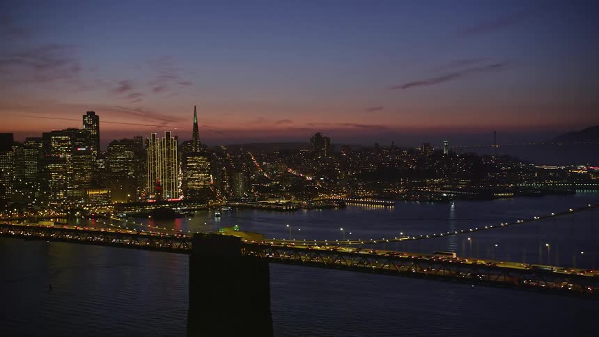 The bay bridge with san francisco skyline in the background at dusk