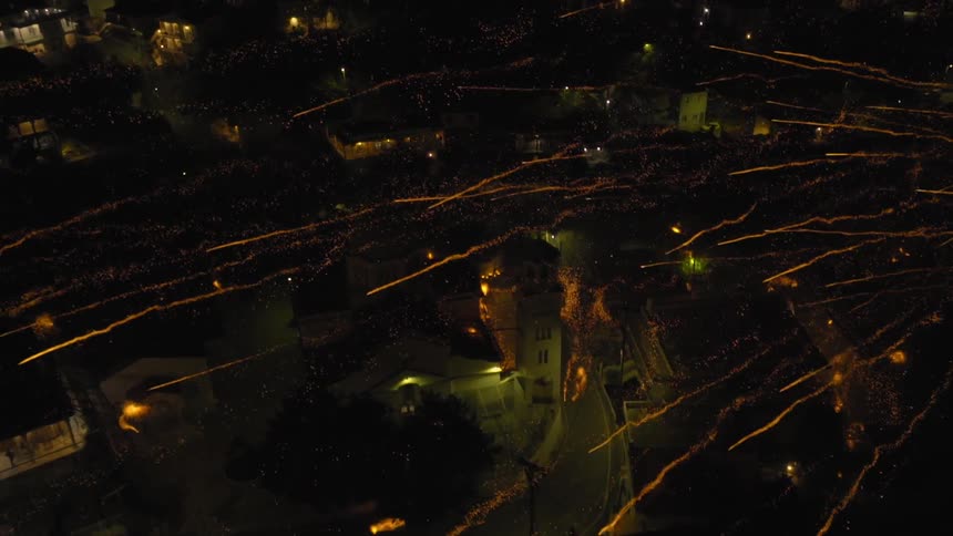 Fireworks shoot over a city at night