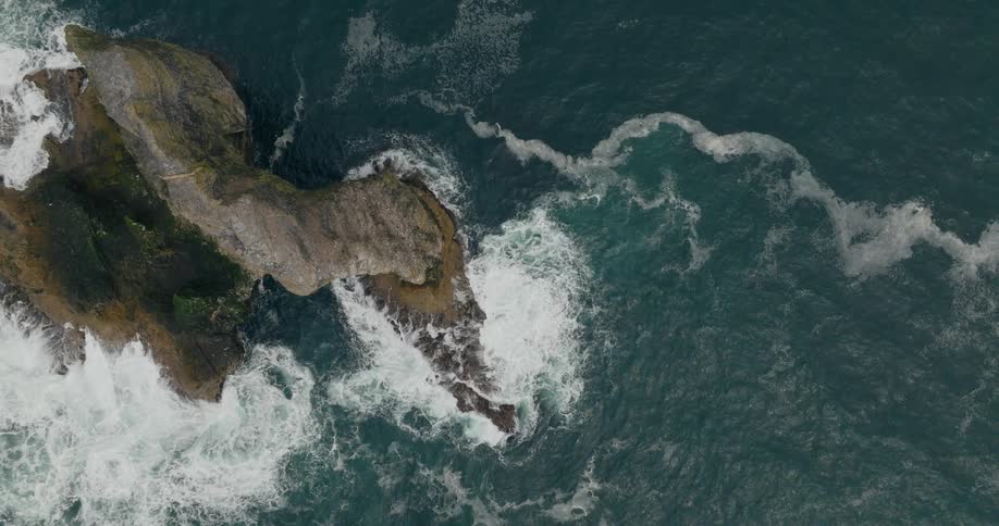 Ocean waves hitting a coastal rock formation