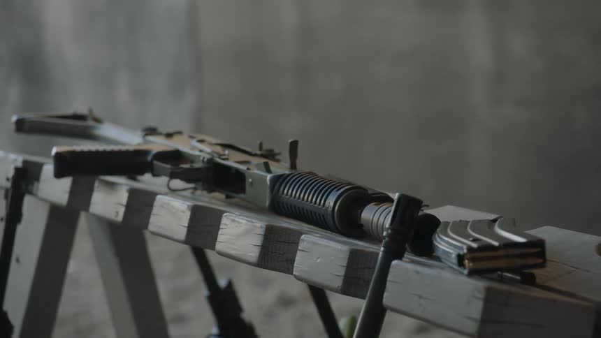A soldier picks up a rifle
