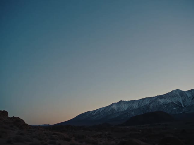 A mountain range landscape at dusk