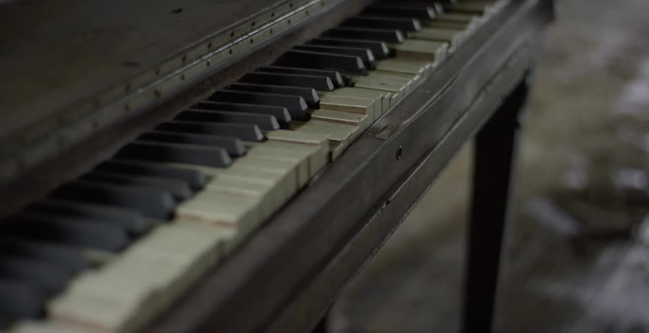 A closeup view of an old worn out piano in a state of disrepair