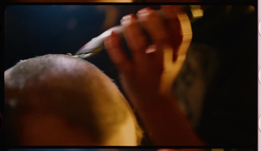 A man is getting his head shaved