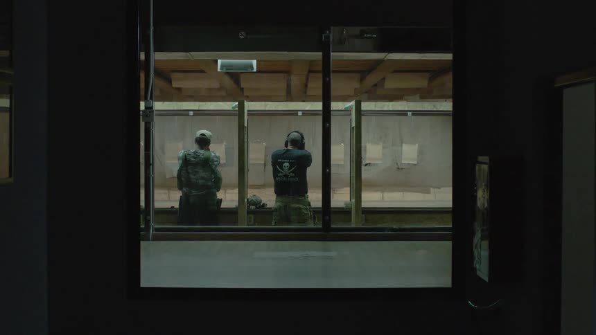 Two men are shooting in the firing range
