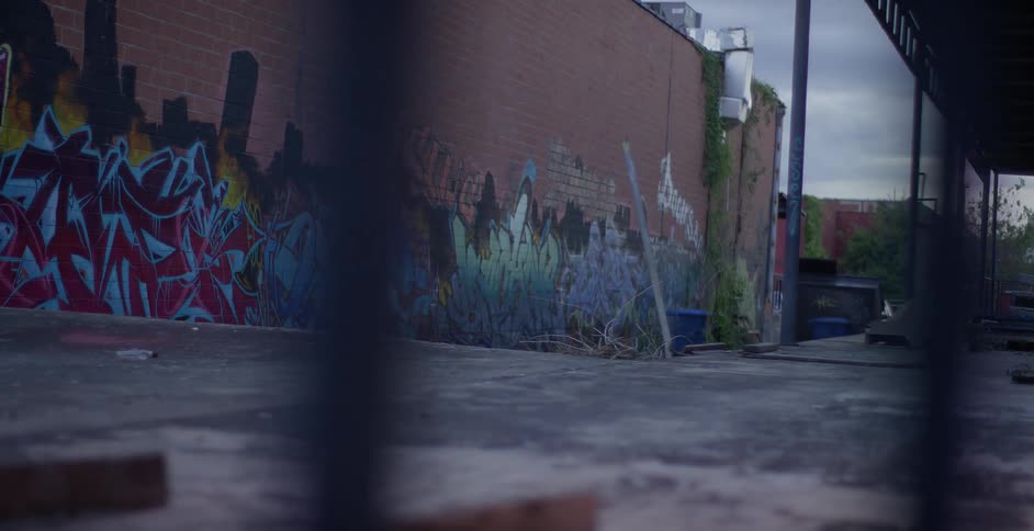 An urban landscape with graffiticovered walls and various objects scattered around
