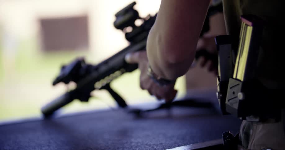A man picks up a firearm at a shooting range
