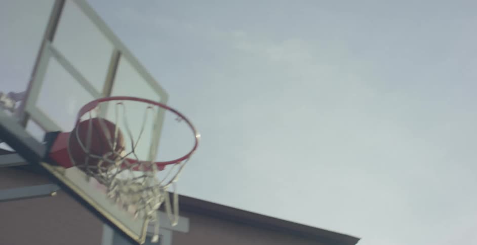 A basketball sails through the air and goes through the net