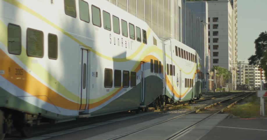 Passenger train passes through the intersection near an office building