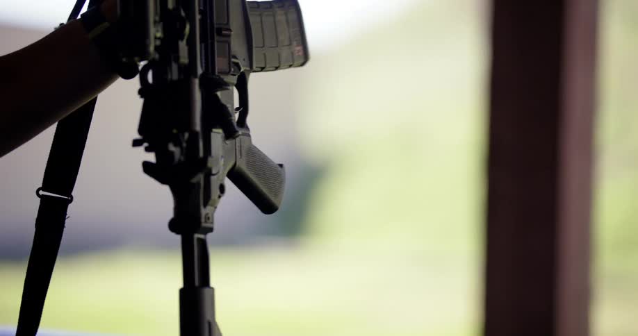 A man is carrying a rifle