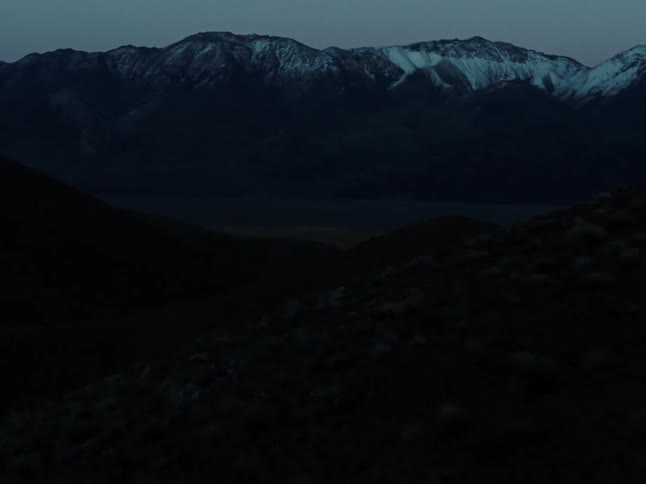 Mountains hem in a large valley grassland