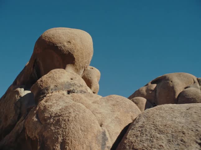 Stones and rocks placed one on top of the other against the cloudless blue sky