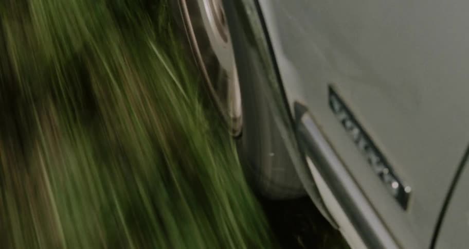 A car goes off the side of a road onto grass