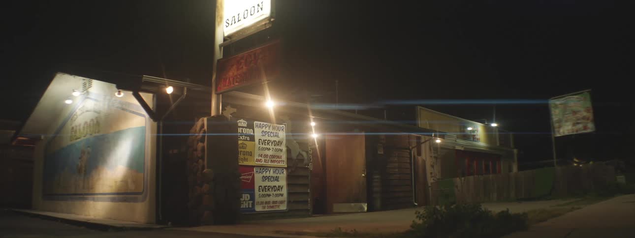 House with banners and signs illuminated at night