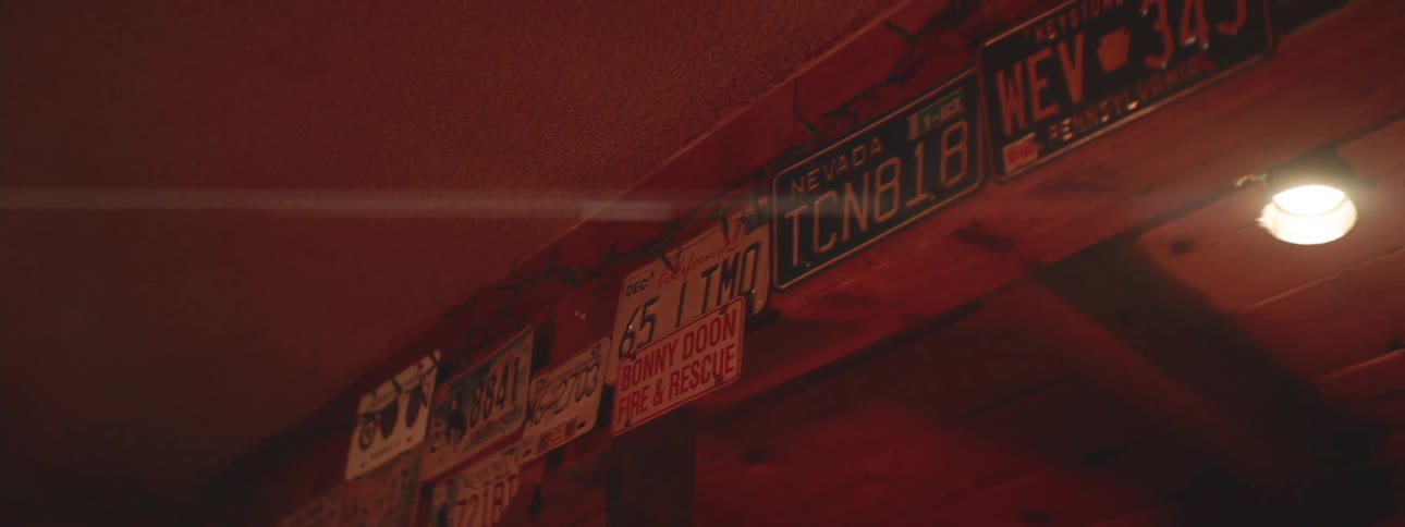 Several license plates in a dark interiora
