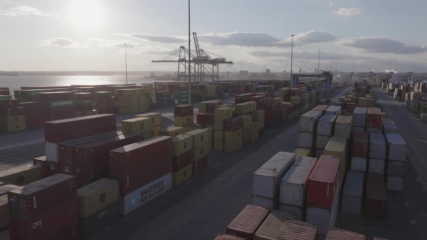Aerial panorama of a distribution center full of containers by the sea
