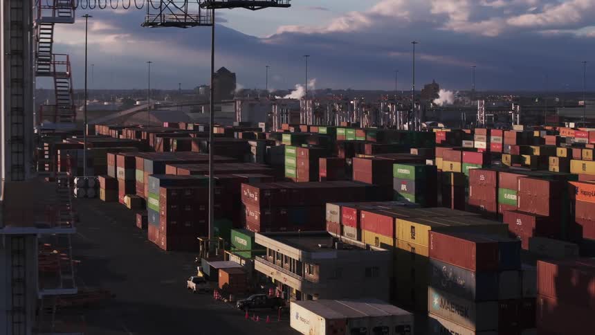 Shipping containers are stacked in the port