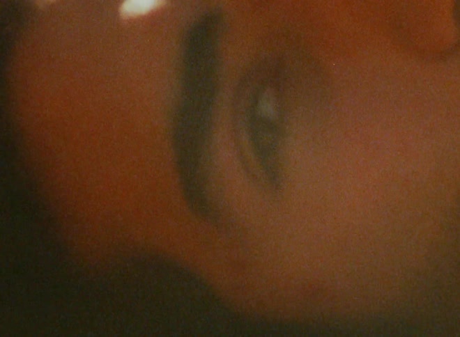 Extreme closeup on the face of a man lying in the field