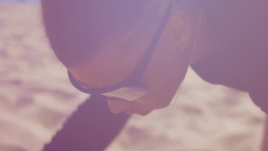 A woman is resting in the sand