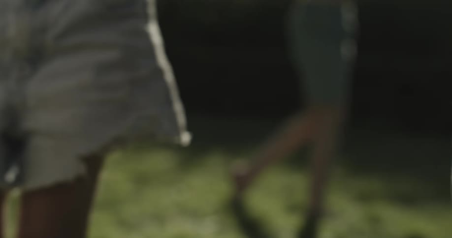 People stand and walk on lawn