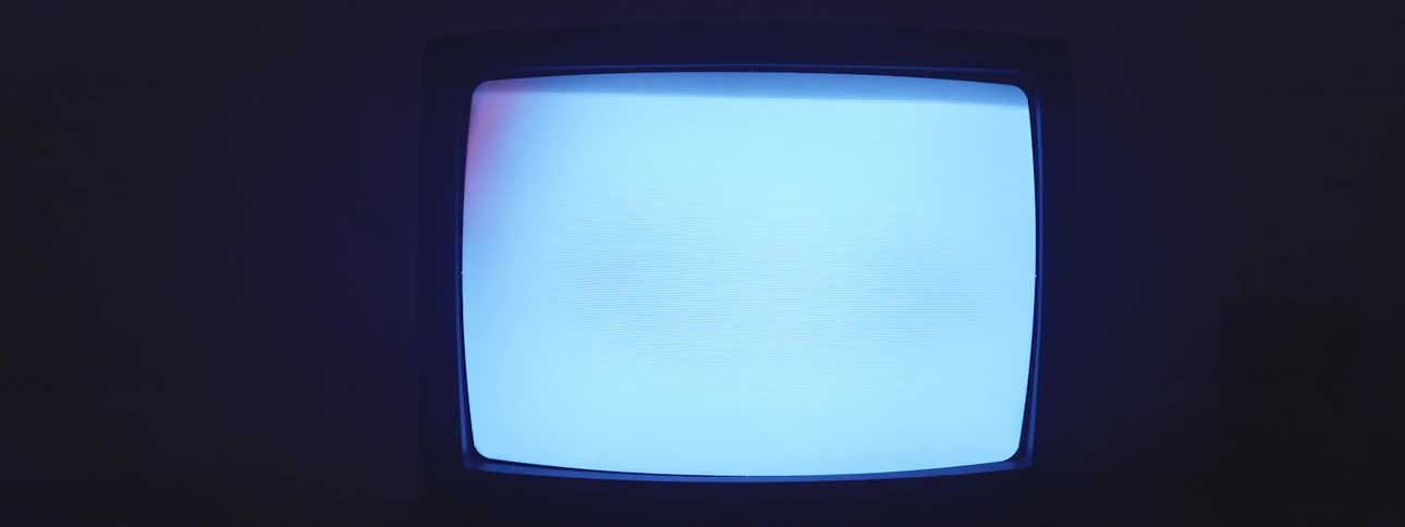 A crt tv shows a blue screen with a flashing black bar