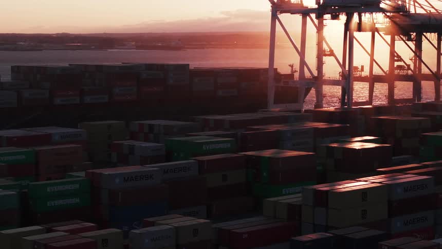 Aerial view of a port with containers on a morning with a red sky