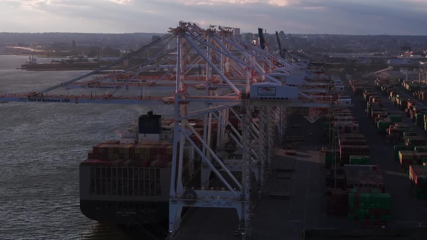 Aerial panorama of a port with cargo boats and stacks of containers on a morning