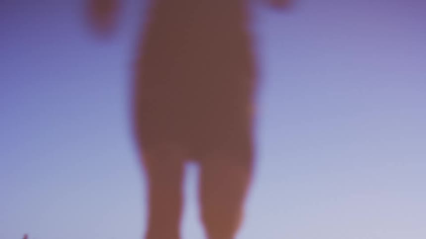 Silhouette of a person running in an openair environment with the blue sky