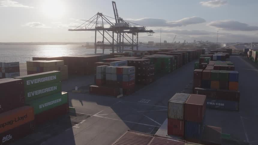 A harbor full of cargo containers and a crane to move them