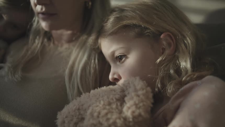 A clip of mother and two daughters reading