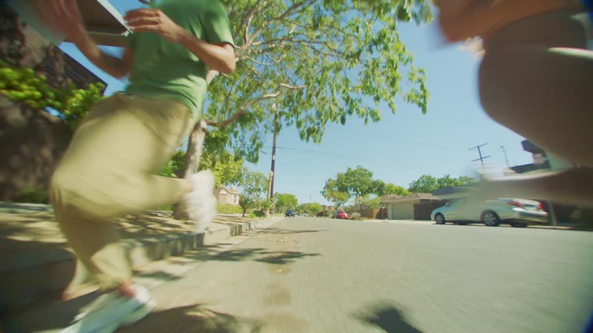 Man and woman running side by side on the street of an urban city during the day
